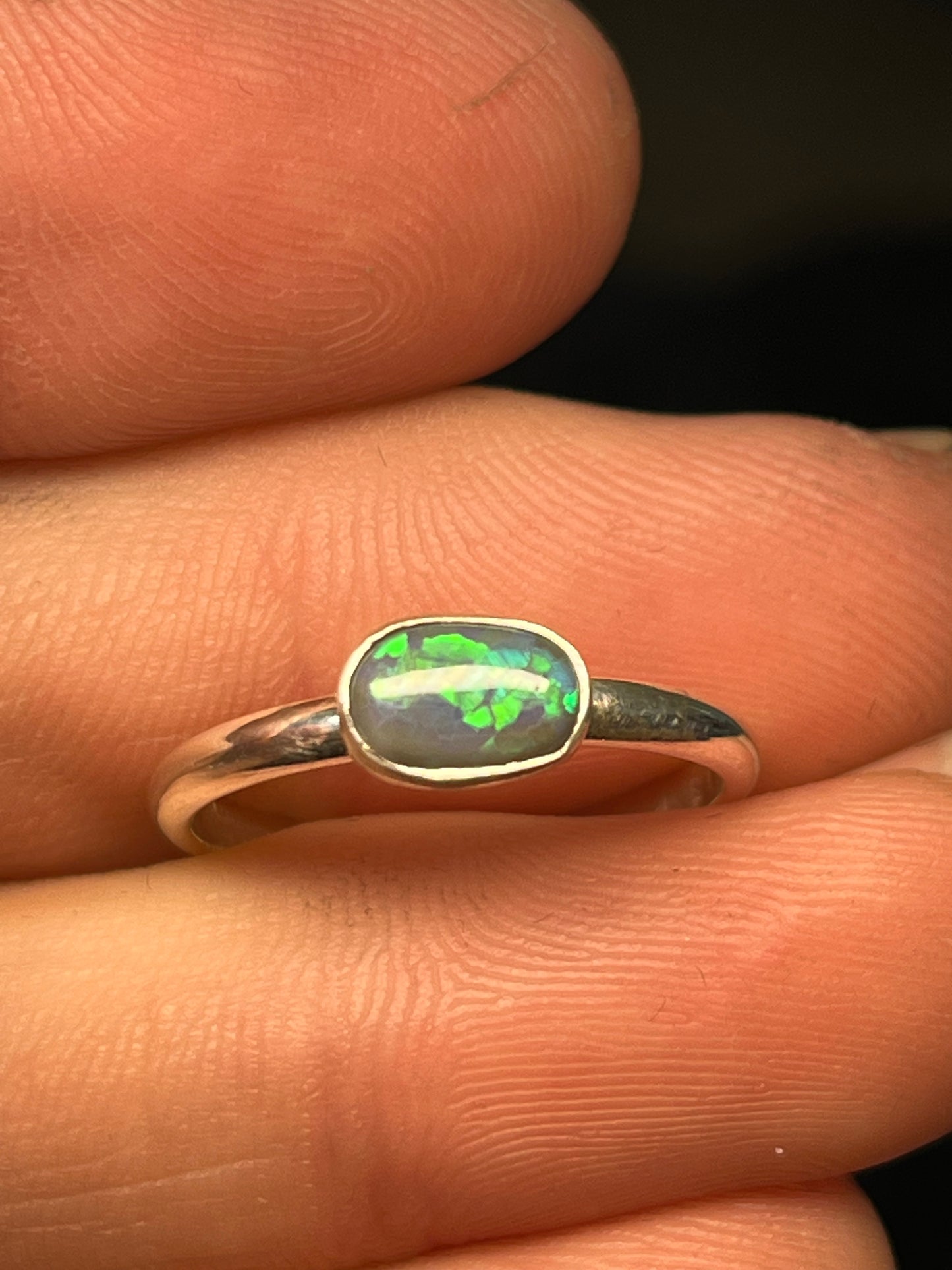 Lightning Ridge silver ring with a stunning lightning rage black Opal showing Green and blue.
