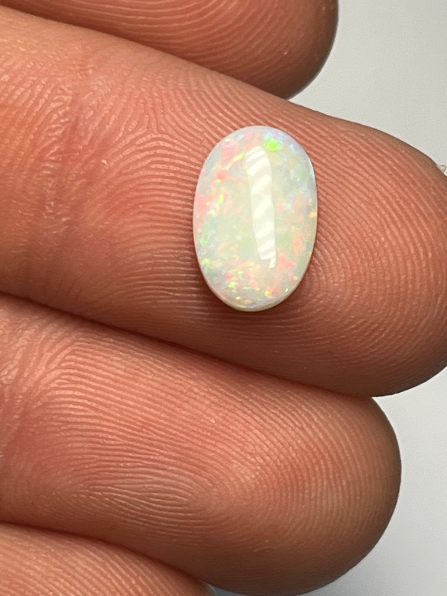 Coober Pedy 1.9ct multicolour with bright red flashes.